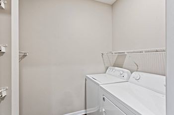 A white laundry room with a washer and dryer